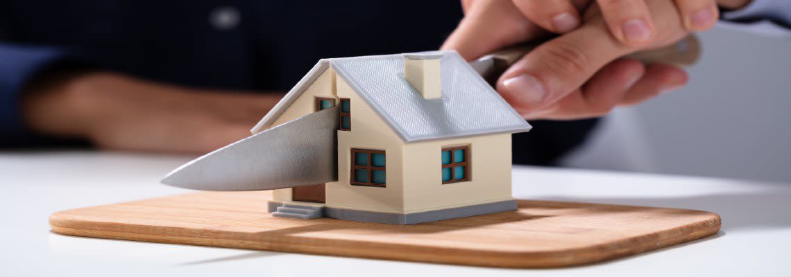 Small Home Being Cut in half with a Knife