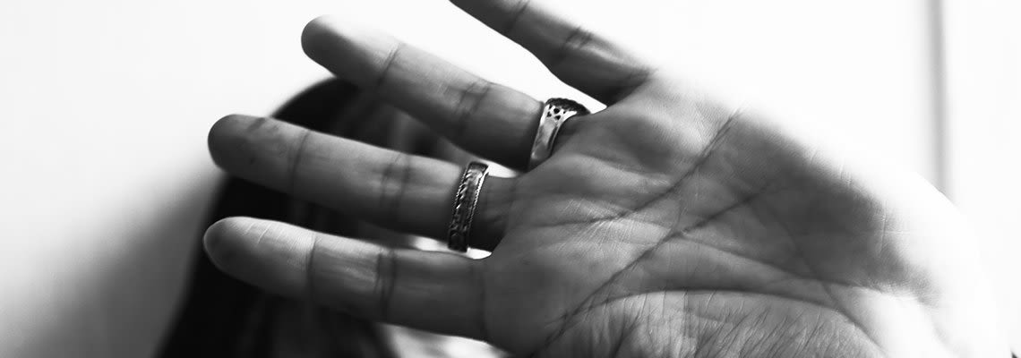 A girl holds her hand in front of her face
