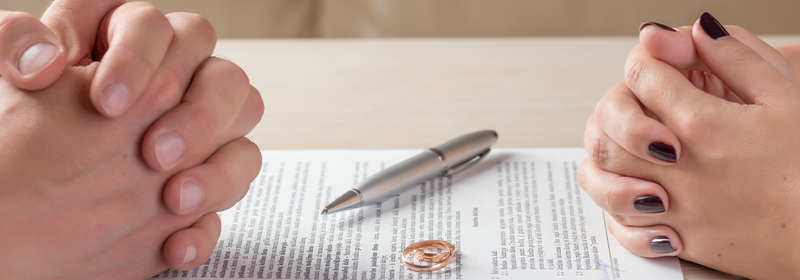Wife and Husband Signing Divorce Documents