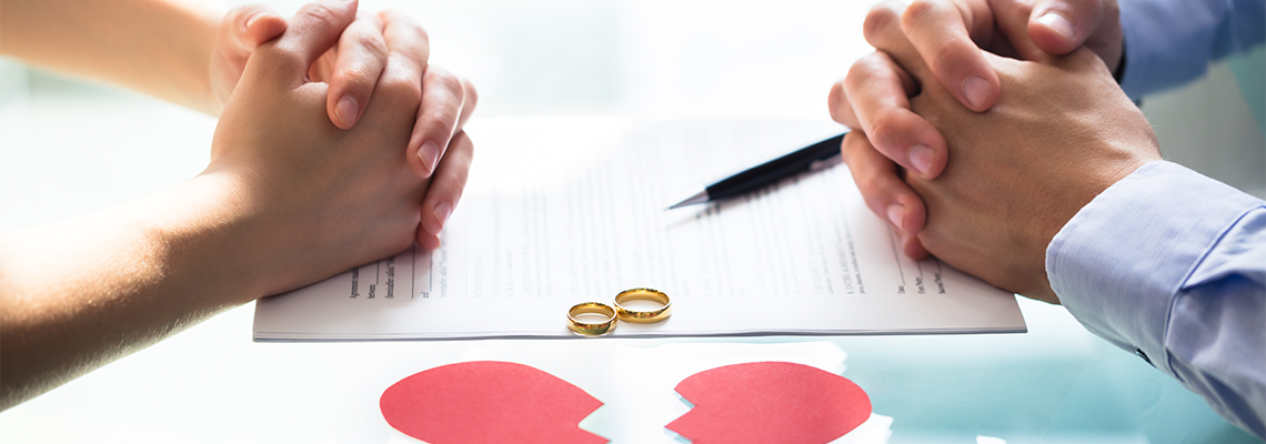 Two people with hands clasped on a document