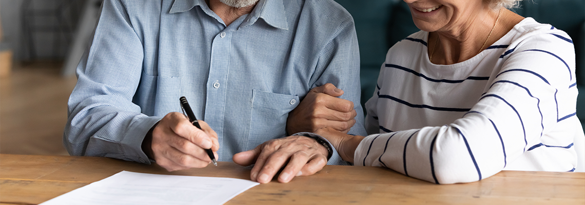 60s elderly spouses at lawyer office sign marriage contract