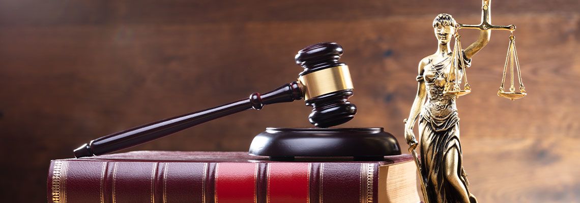 Lady Justice Near Gavel Over Law Book