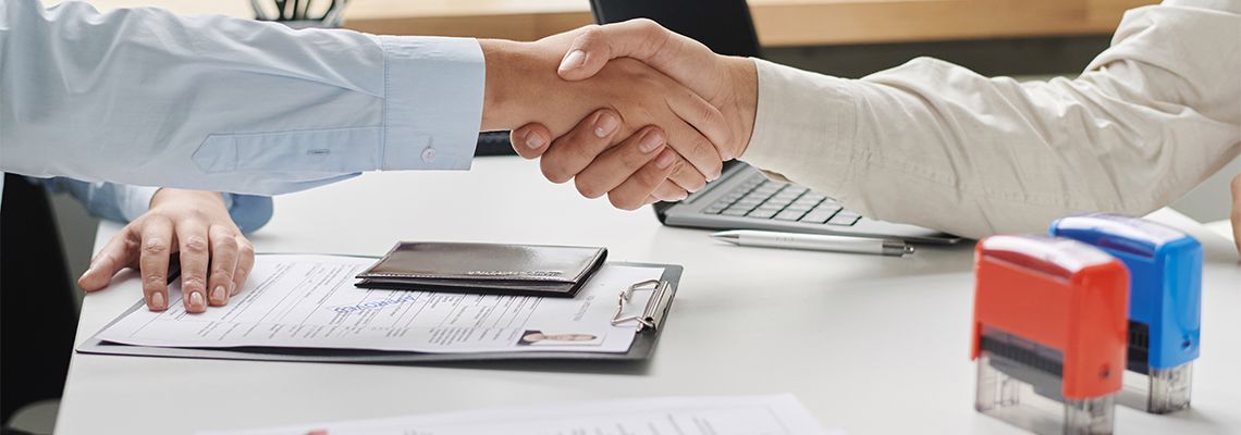 Women shaking hand with visa center employee