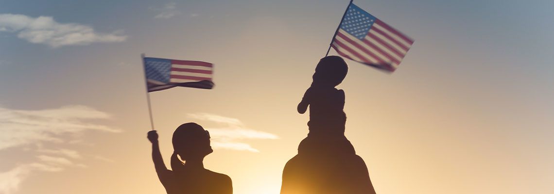 Family waving flag of USA