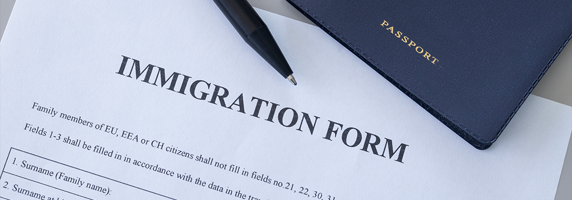 Immigration form and passport on desk