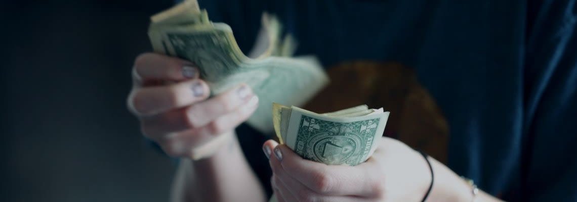 Person counting cash in their hands