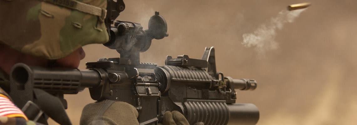 Soldier firing a weapon in combat