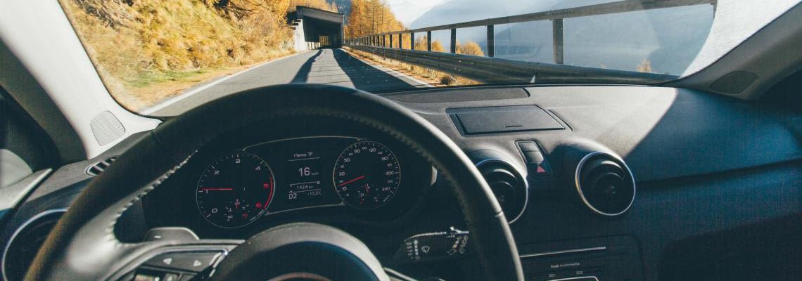 Driver's view of the front windshield of car going through a tunnel