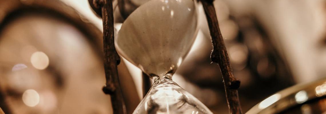 Sepia-toned photo of antique hourglass