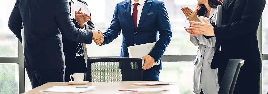 Group of business partners shaking hands