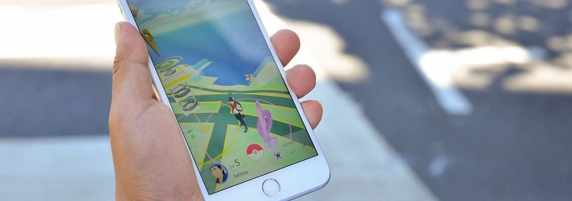 Person holding a phone while playing Pokemon Go