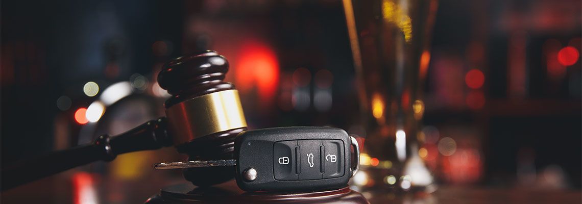 Gavel, Car Keys and Glass of Alcohol in table