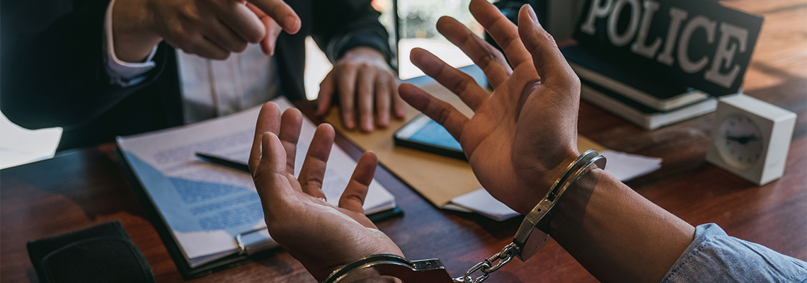 Law enforcement officer interrogating Criminals male with handcuffs