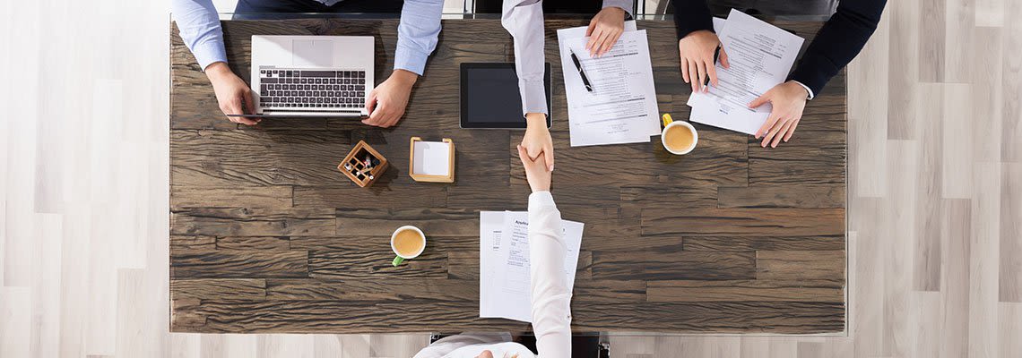 Business people shaking hands at a desk