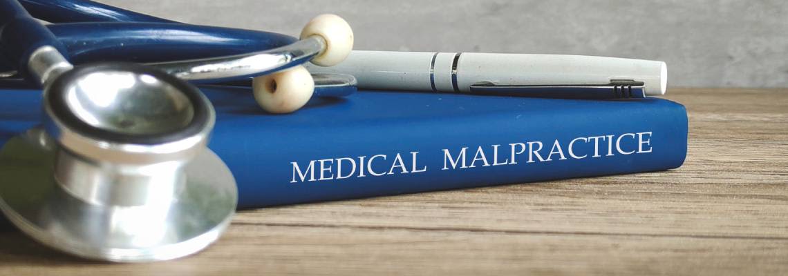 Medical Malpractice Law book and stethoscope