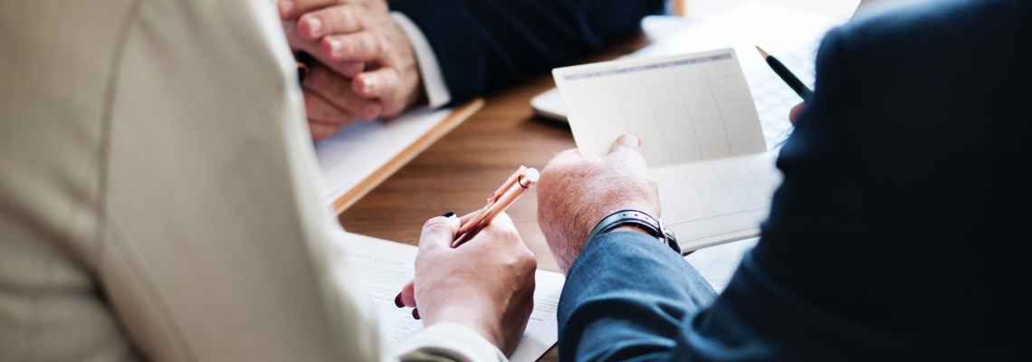 Three Men Having a Meeting and Working on Documents