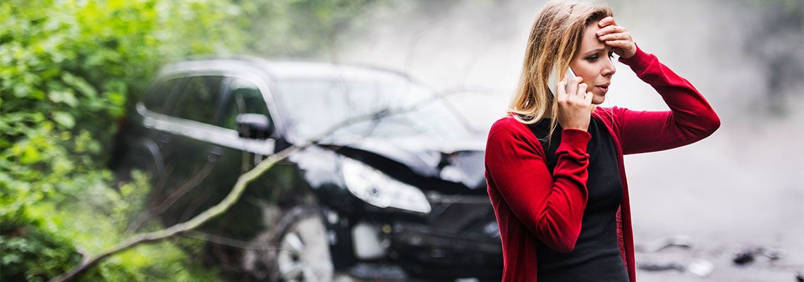 Tensed Woman making call after car accident