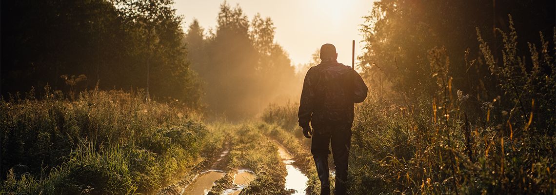 Silhouetted of a hunter with shotgun