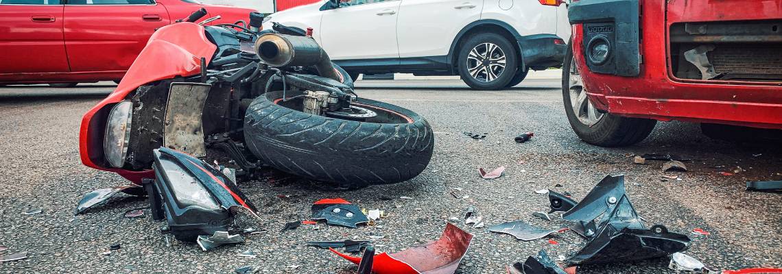 Motorcycle crashes with car in road