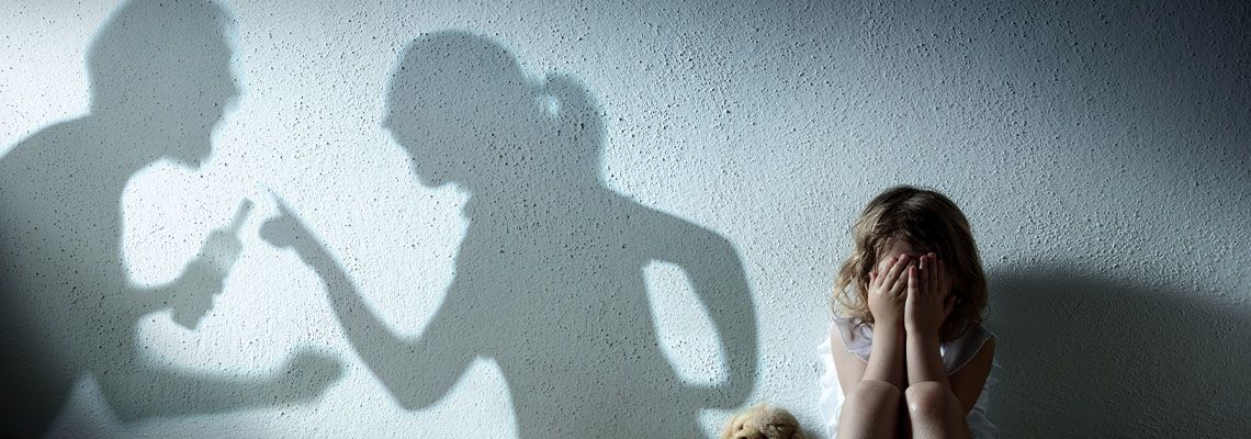 Little Girl Crying with Shadow of Parents Arguing