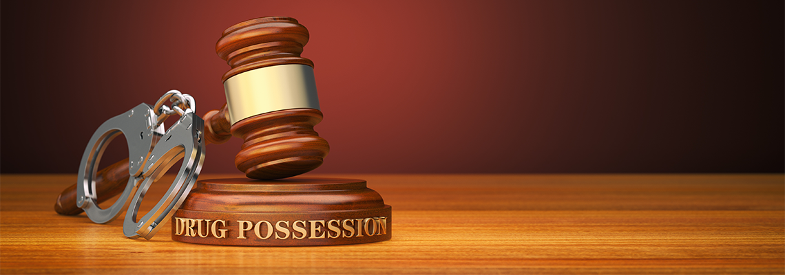 Drug Possession, Gavel and Handcuff on Wooden Table