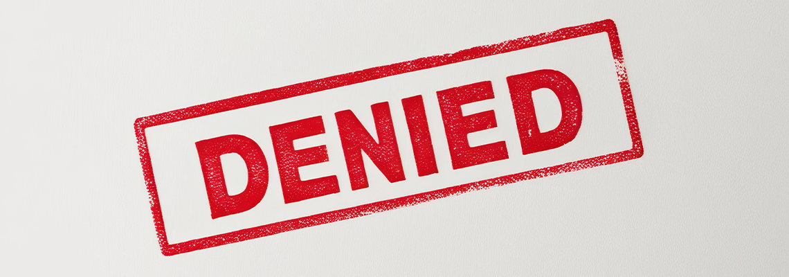 A bold red 'DENIED' stamp on a light background, symbolizing rejection or refusal
