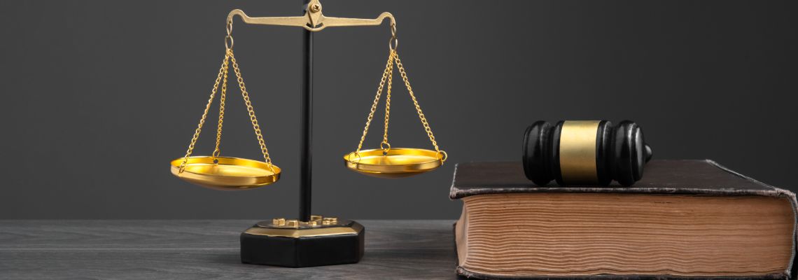 Law book, gavel and scale of justice
