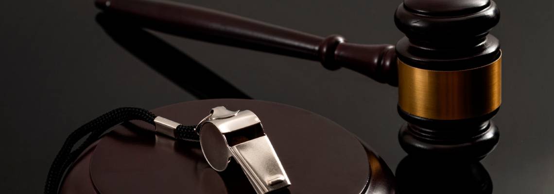 Whislte and gavel in table, Whistleblower protection concept image
