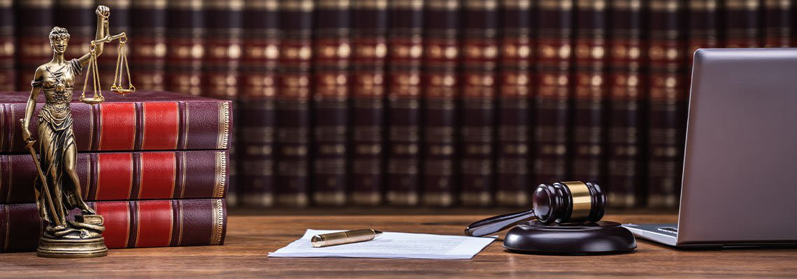 Laptop Books and Gavel on Desk