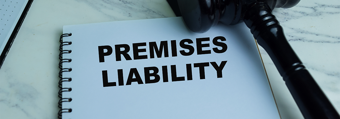 Premises Liability write on book with gavel isolated on Wooden Table