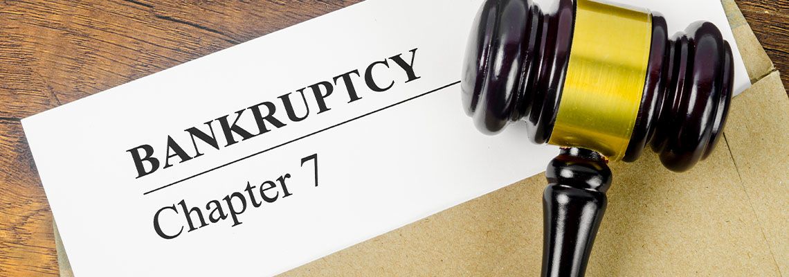 Bankruptcy Chapter 7 text on Document with gavel in table