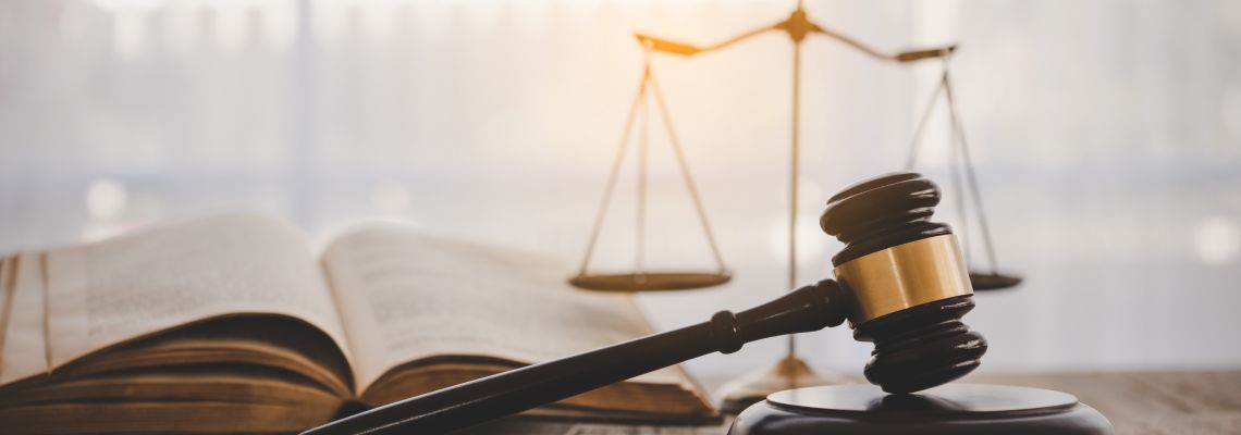 Gavel, Scale of Justice and law book on table