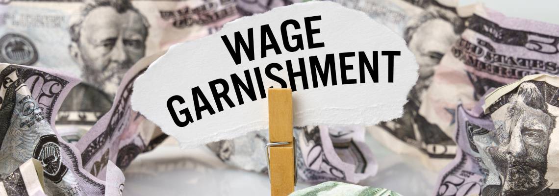 Dollar on table with paper with word Wage Garnishment