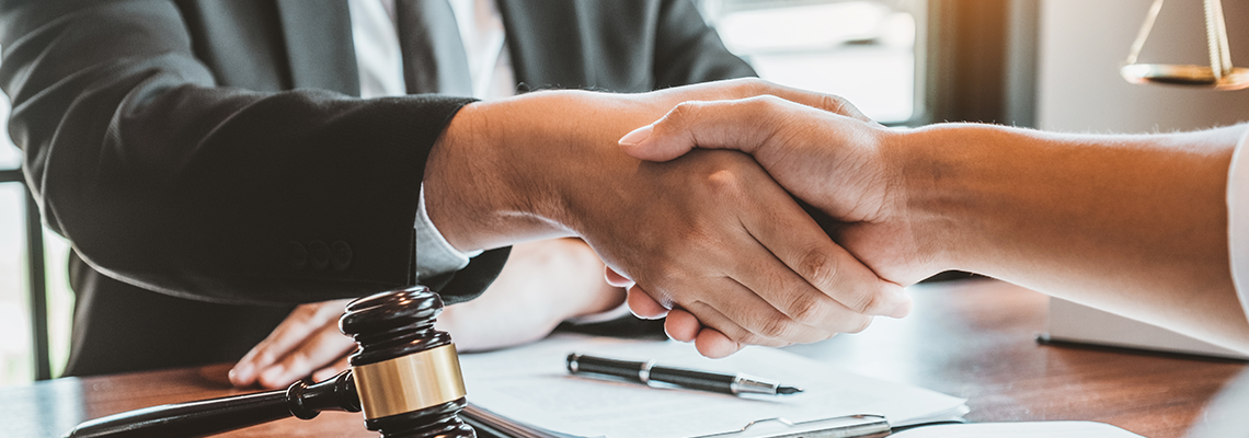 man shaking hands with an attorney
