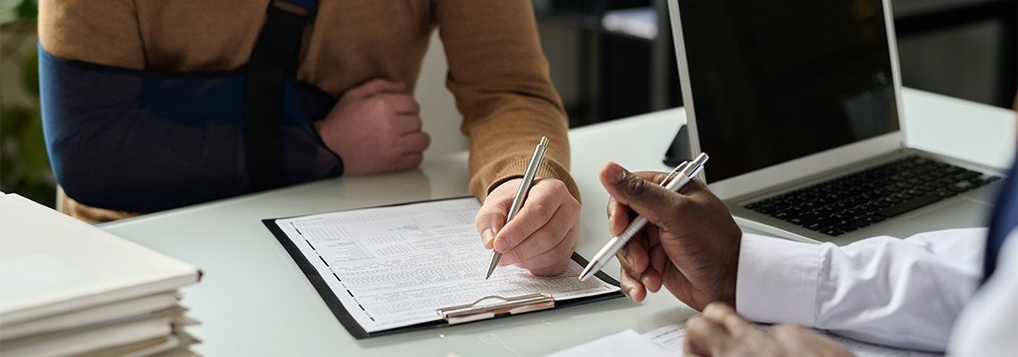 Injured man filling in medical insurance form