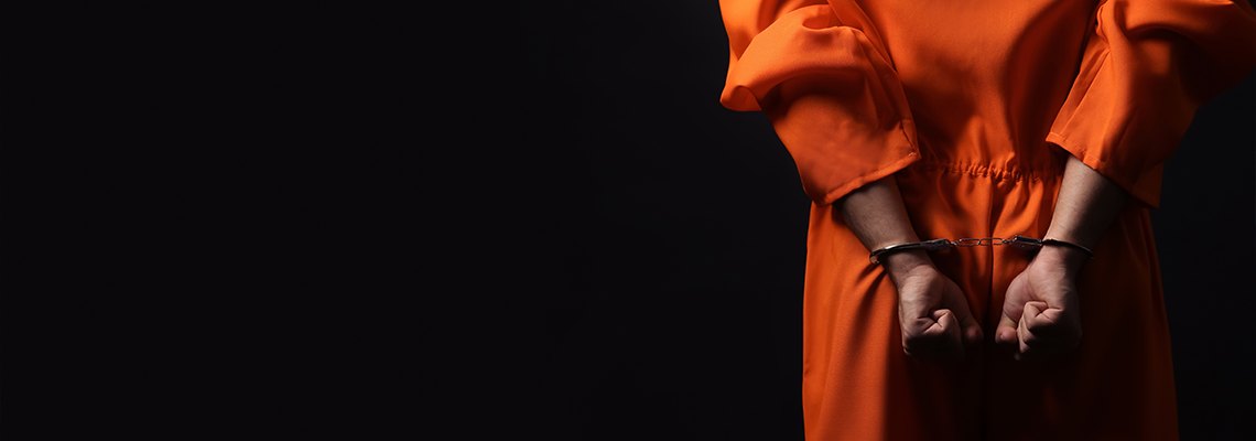 Prisoner in Jumpsuit with Handcuffs