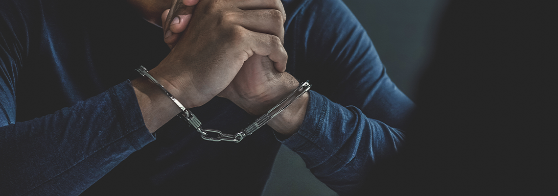Criminal Man with Handcuffs in Interrogation Room