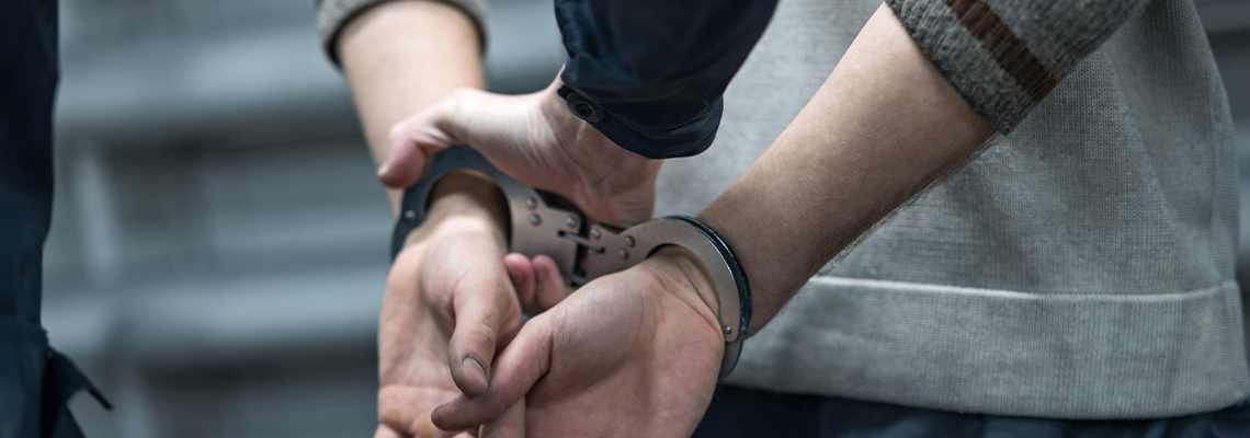 Police Handcuffing the Arrested Person