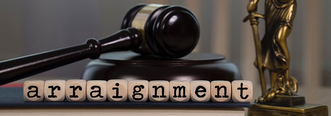 The word arraignment composed of wooden dices along with gavel