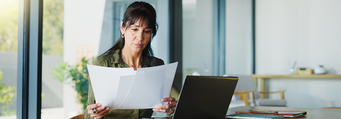 Business, woman and document with laptop at house for real estate, property report and contract