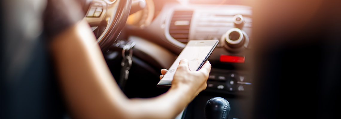 Driver looking down at their phone while driving