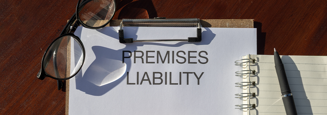A legal document titled “Premises Liability” placed in a clipboard resting on the desk