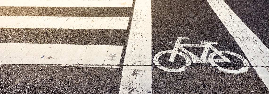 Bike lane symbol with crosswalk on asphalt street