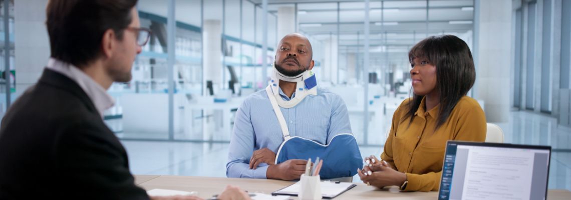 Injured man and his wife with insurance agent