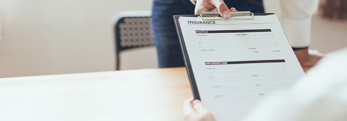 Person handing an insurance claim to another person