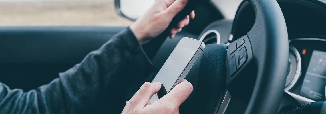 Man texting while driving