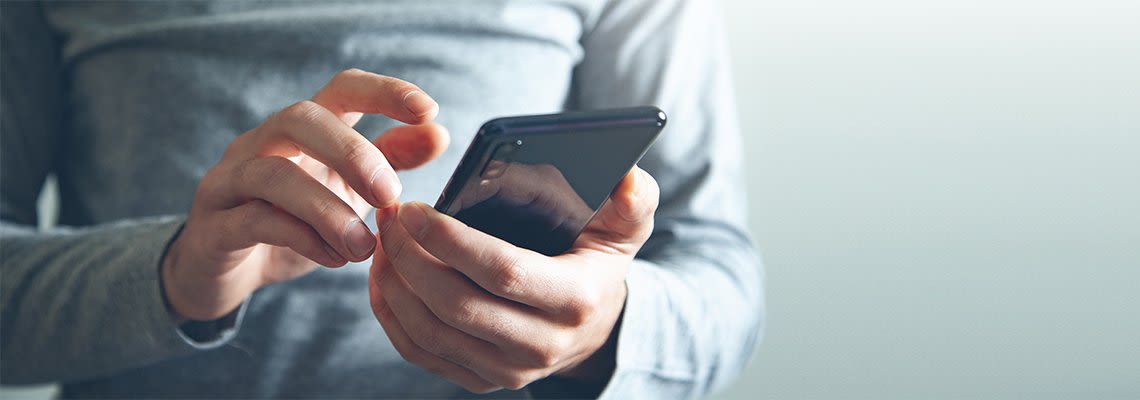 Person holding smart phone in hands