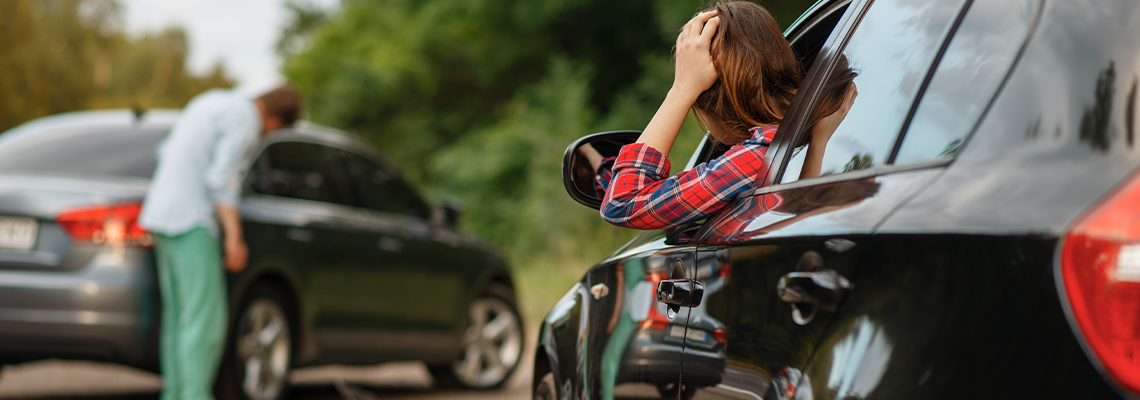 Male and Female Drivers After Car Accident on Road