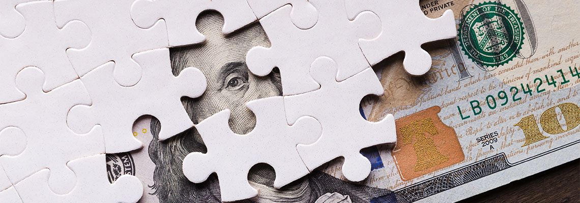 American dollar hidden under puzzle pieces