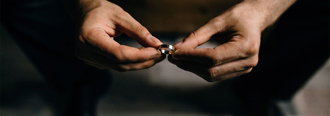 Man holding wedding ring in hand